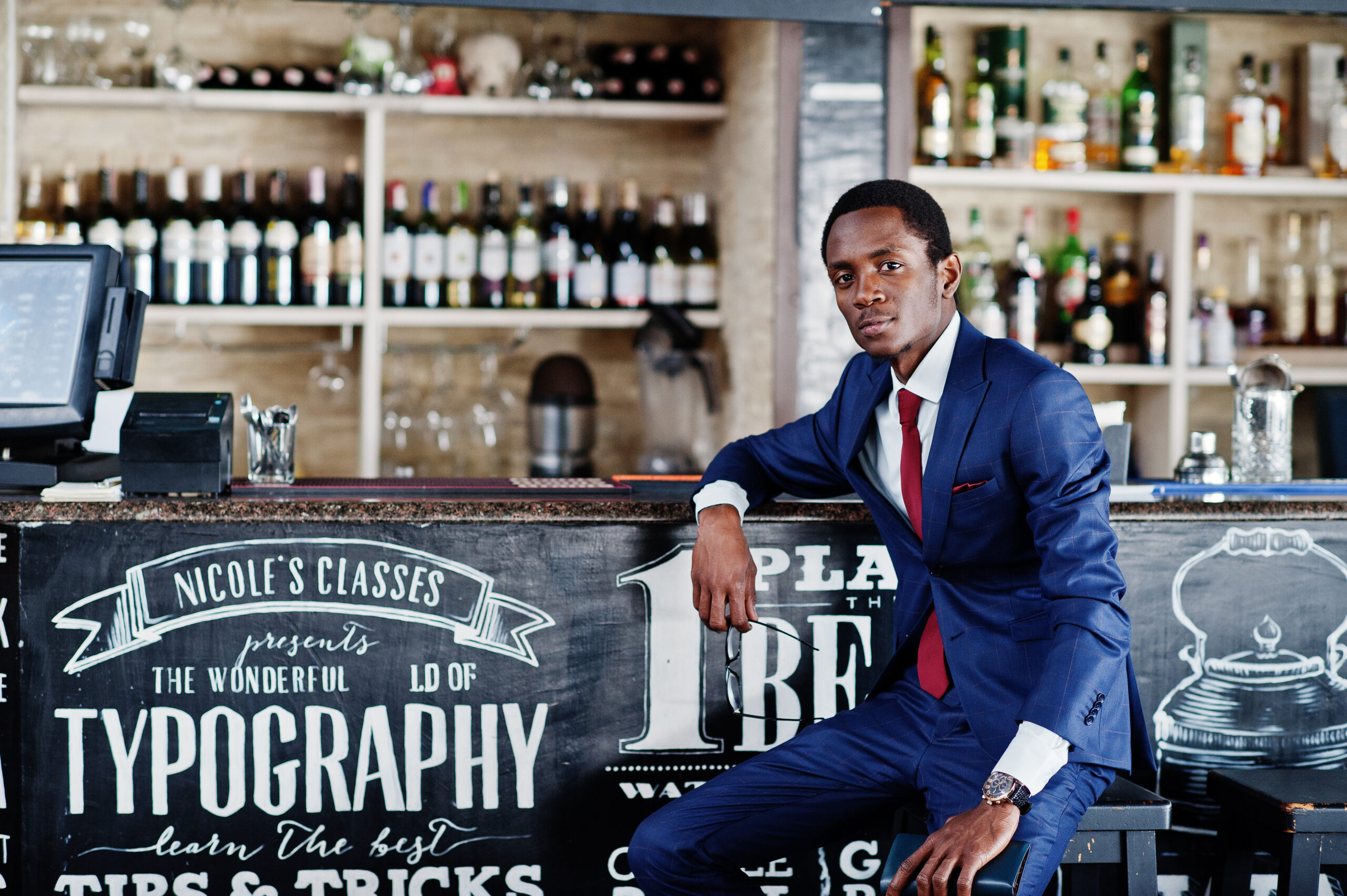 African american happy successful student at suit sitting on bar